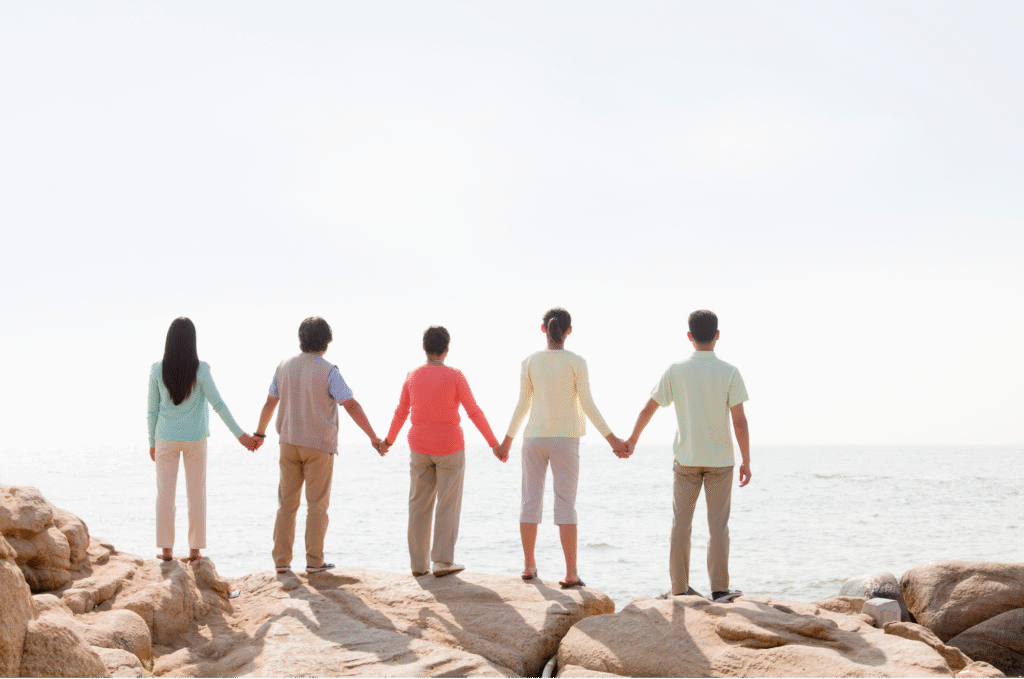 A family holding hands in alignment with the plan they crafted with AgingUnbound's checklists and resources