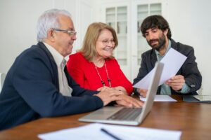 Older parents and adult son smiling during a family conversation at home